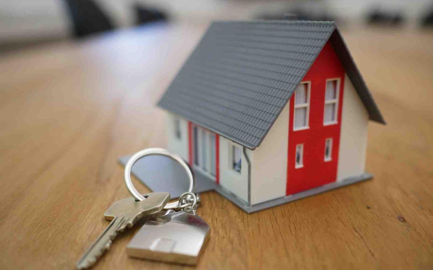 Set of keys beside miniature house